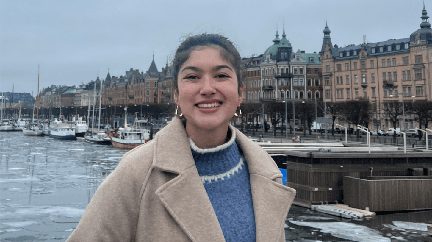 Loyola University Chicago student smiling at Stockholm waterfront during study abroad